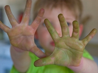 A child showing their painted hands