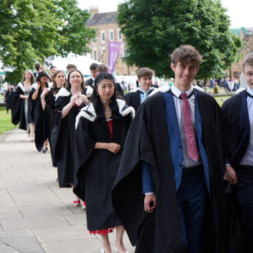 A group of students in gowns walking