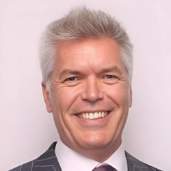 Man wearing a suit and tie smiling