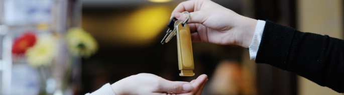 Hotel receptionists' hands holding keys