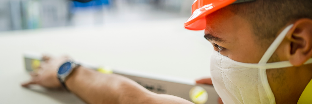 Person wearing a face mask and hard hat