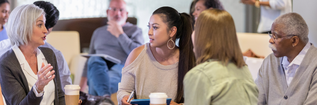 Mature caucasian female facilitates a group session