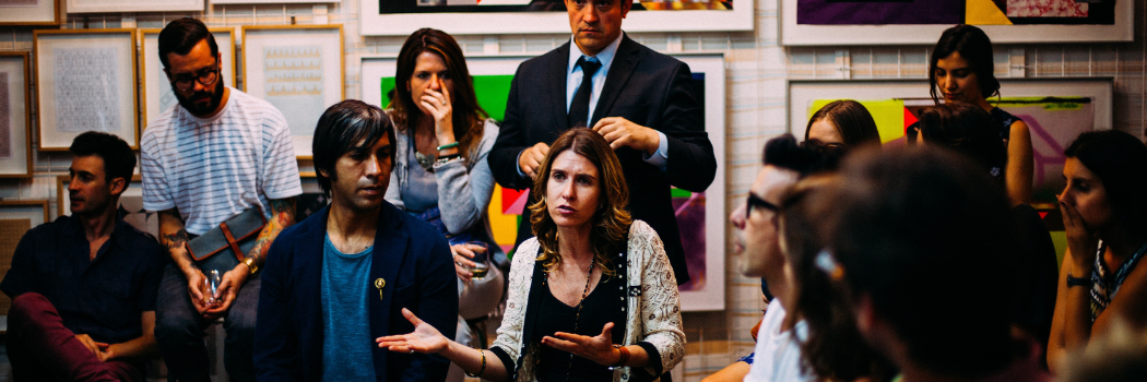 A group of people having a discussion in a meeting room