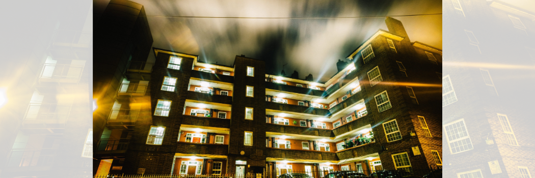 concrete council flat building with exposure at night