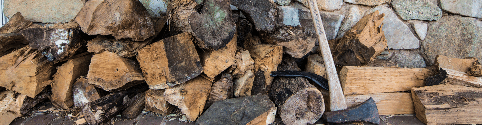 A pile of logs with an axe