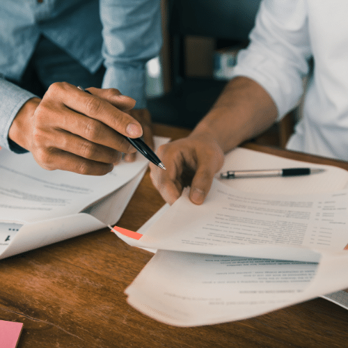 Two people viewing papers on a desk