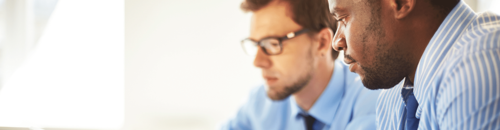 Two business men looking at a laptop