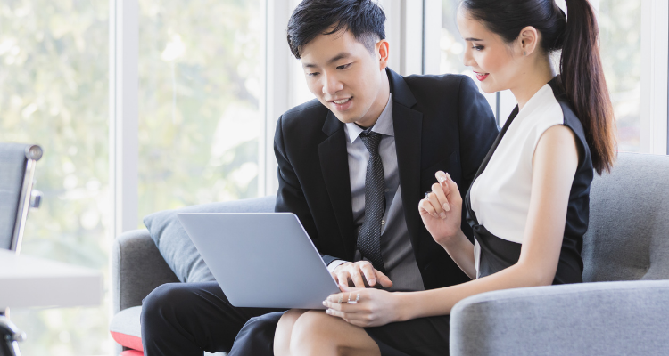 Two business people looking at a laptop