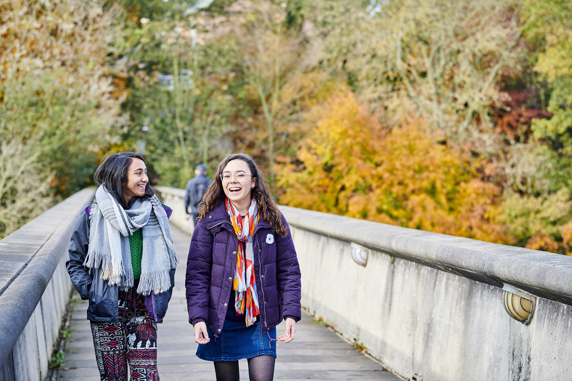 Two students crossing Kingsgate Bridge