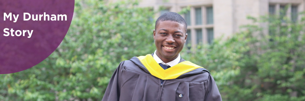 Alumnus Enoch Omale smiling at camera in congregation robes