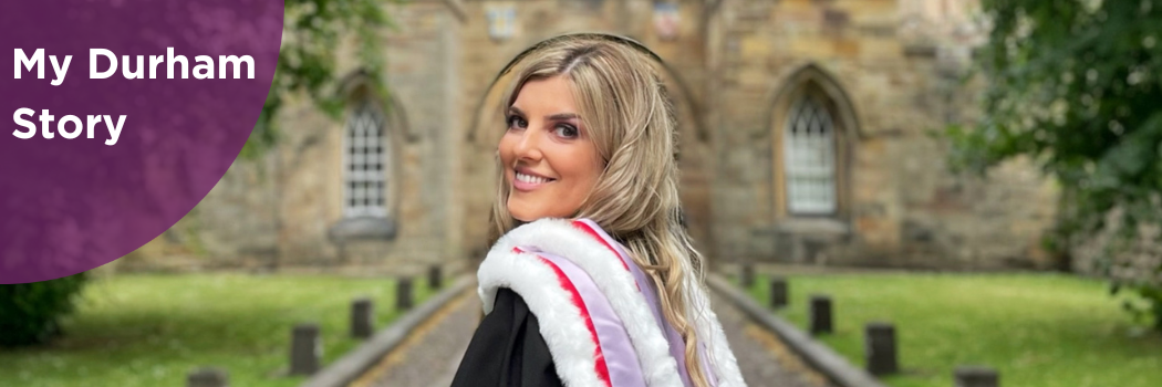 Milica Spasojevic smiling at camera in Durham congregation robes