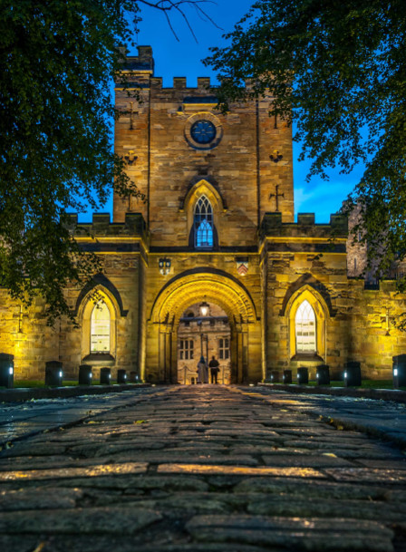 Exterior of Durham Castle lit up at night