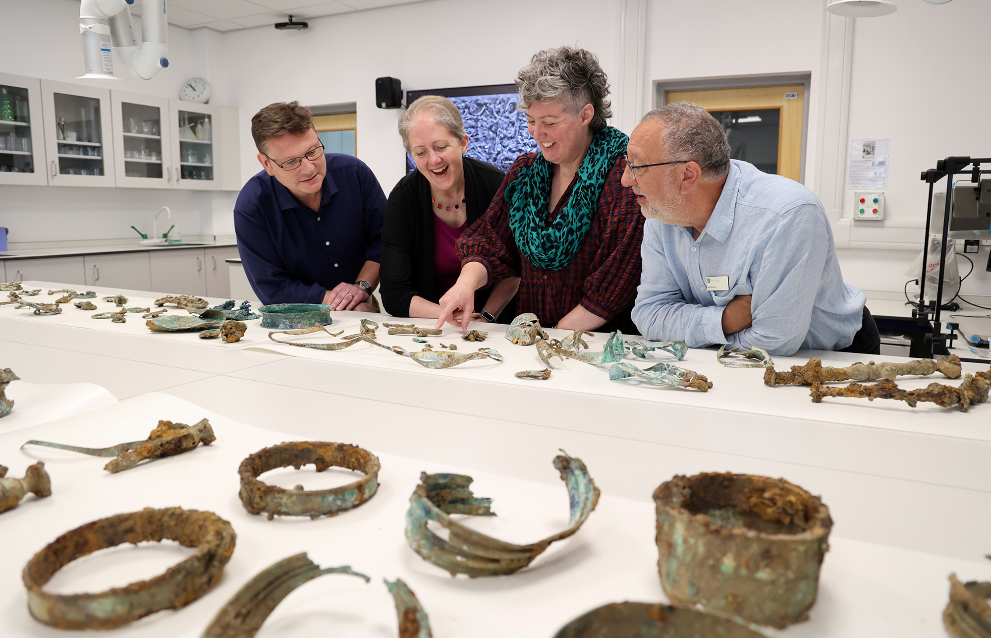 Group of people looking over some of the artefacts which form The Melsonby Hoard. From left to right: Professor Tom Moore, Head of the Department of Archaeology; Dr Emily Williams, Department of Archaeology; Dr Sophia Adams, Curator, The British Museum; and Dr Keith Emerick, Inspector of Ancient Monuments, Historic England.