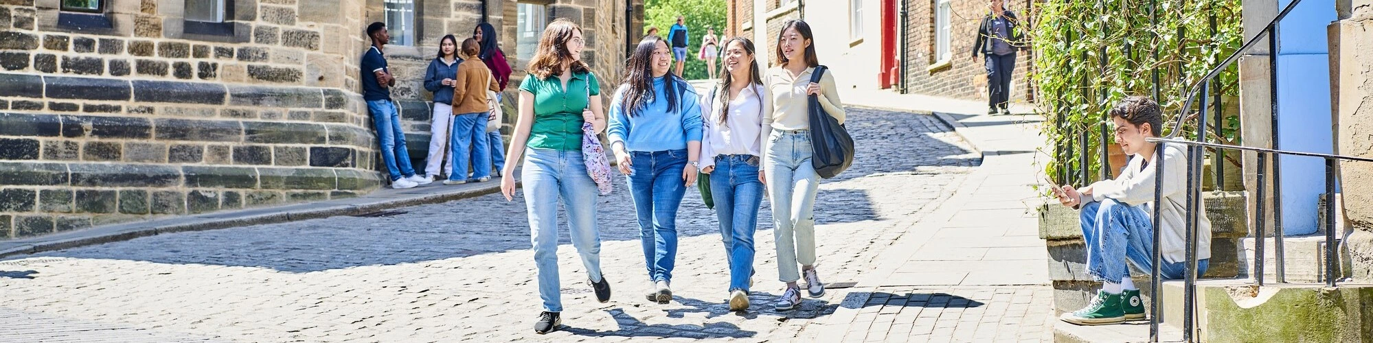 Four students walking through Durham
