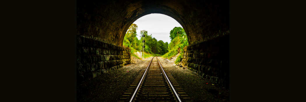 View looking through an old brick railway tunnel.