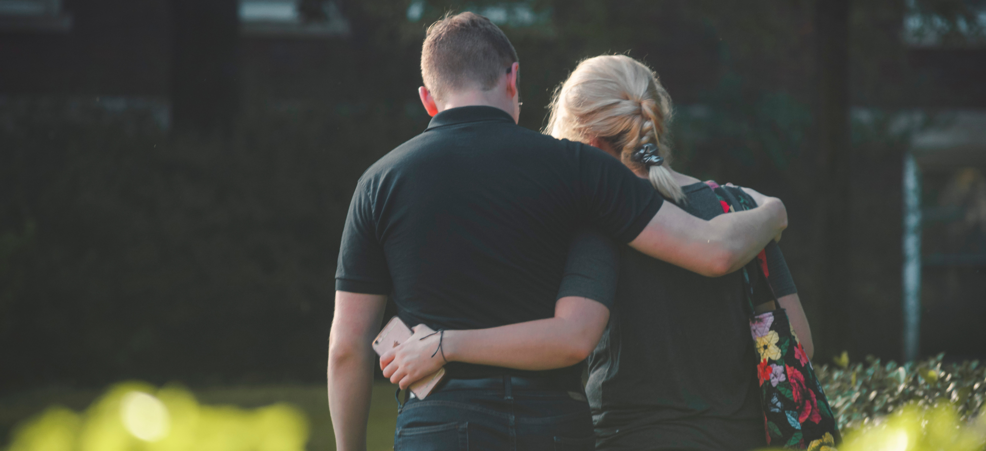 A man and a woman with their arms around each other