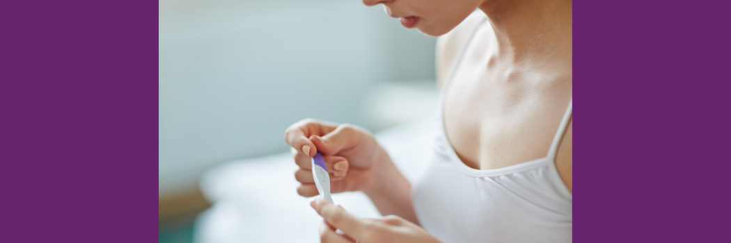 Young woman with pregnancy test in hands