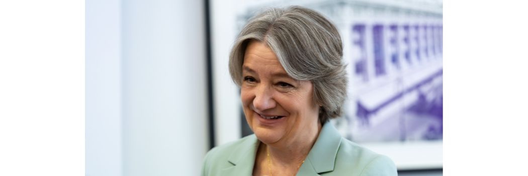 Woman smiling, looking off camera to right