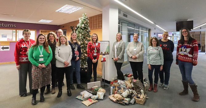 Library staff and charity representatives at the gift presentation at Bill Bryson Library