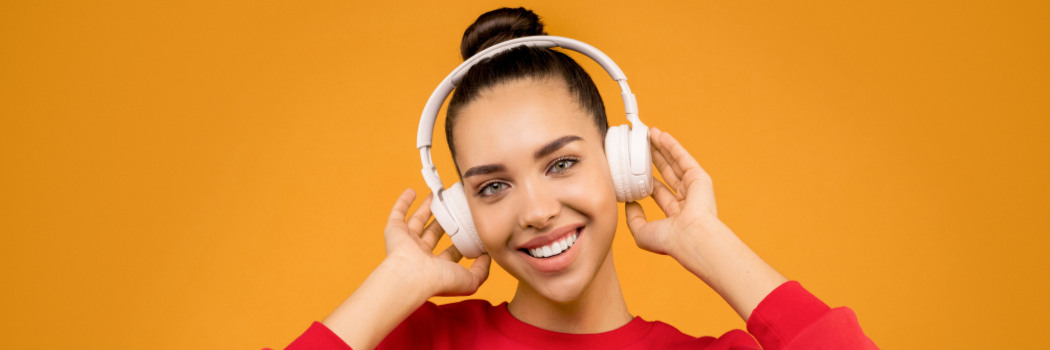 A girl listening to music through her headphones.