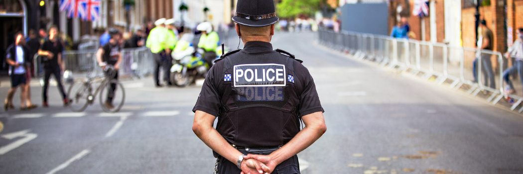 Male police officer standing in quiet street