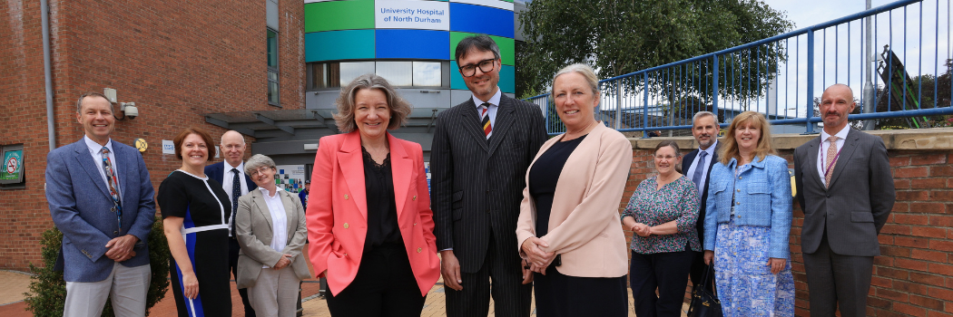 A large group of Durham and NHS representatives standing outside Durham Hospital