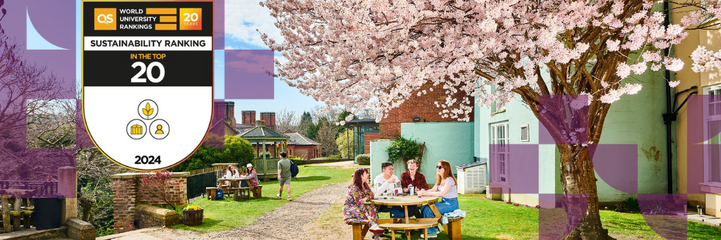 Students sitting at a table in an attractive garden with a blossom tree in full flower