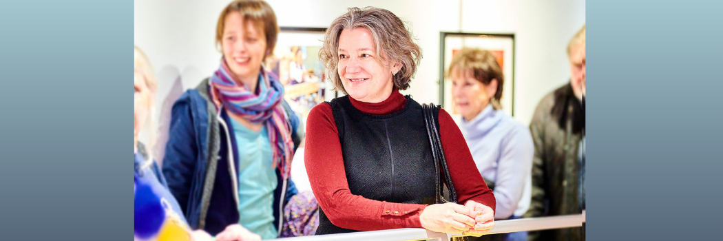 Vice Chancellor Karen O'Brien smiling resting on a bannister