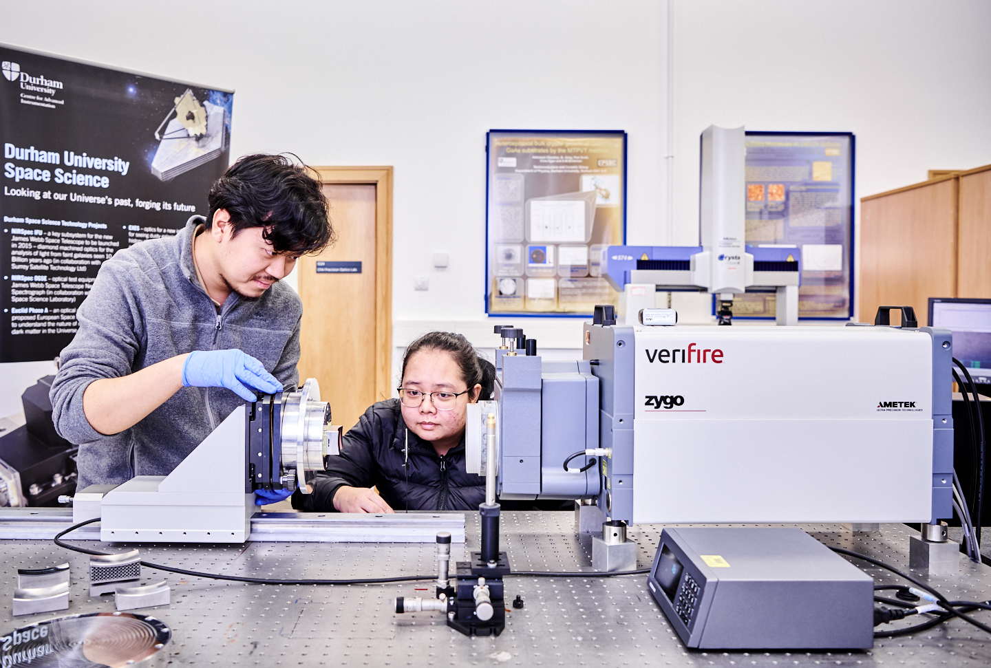 male and female researcher working on instrumentation equipment