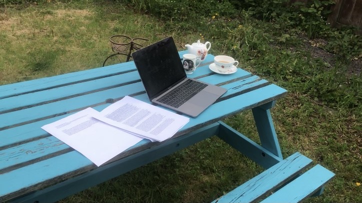 laptop on a desk with papers