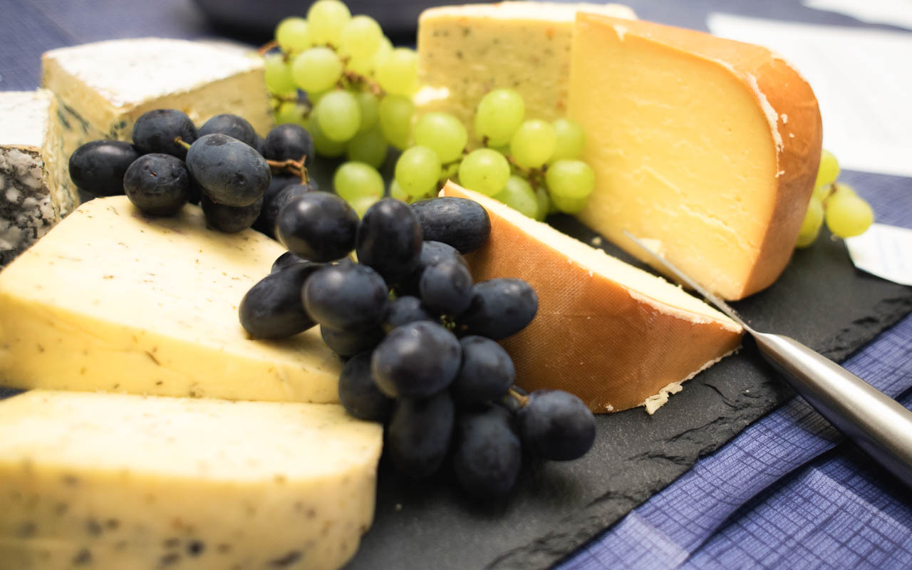 Selection of cheeses and grapes on a platter