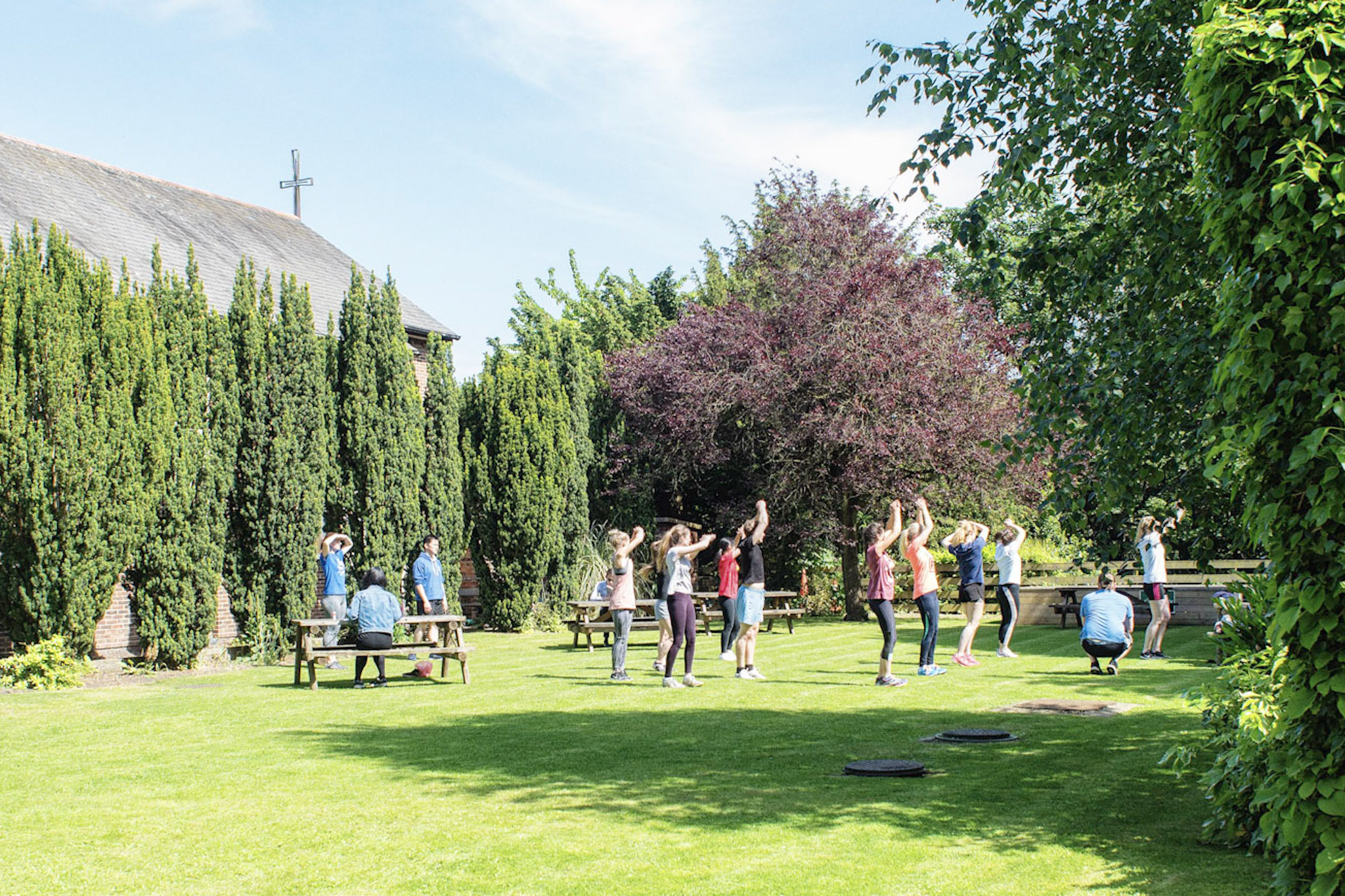 Students exercising outside in the gardens
