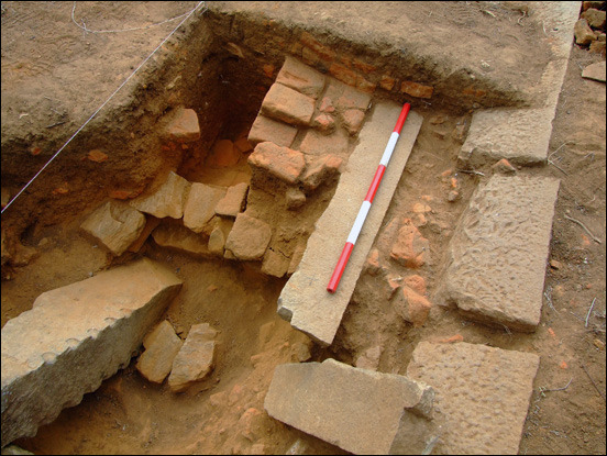 Photograph of an archaeological excavation of stone and brick structural remains