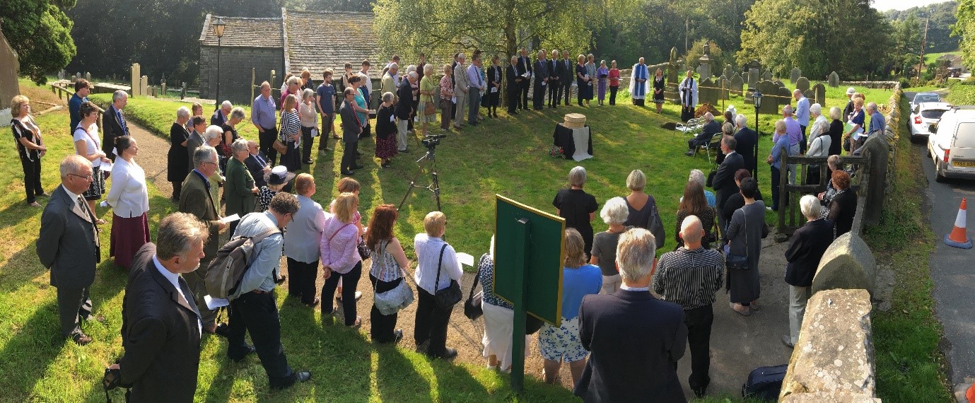 Skeleton reburial surrounded by a large crowd of the community