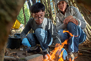 Students prepare a fire in the Botanic Garden dedicated experimental area