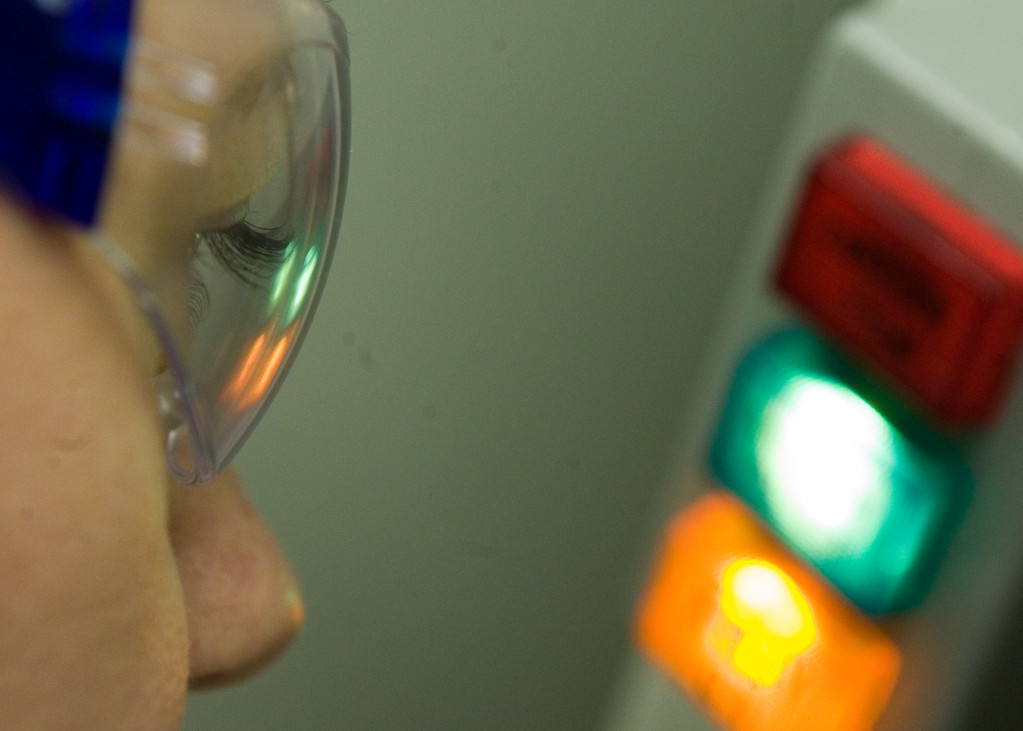 A student with googles looking at some lights