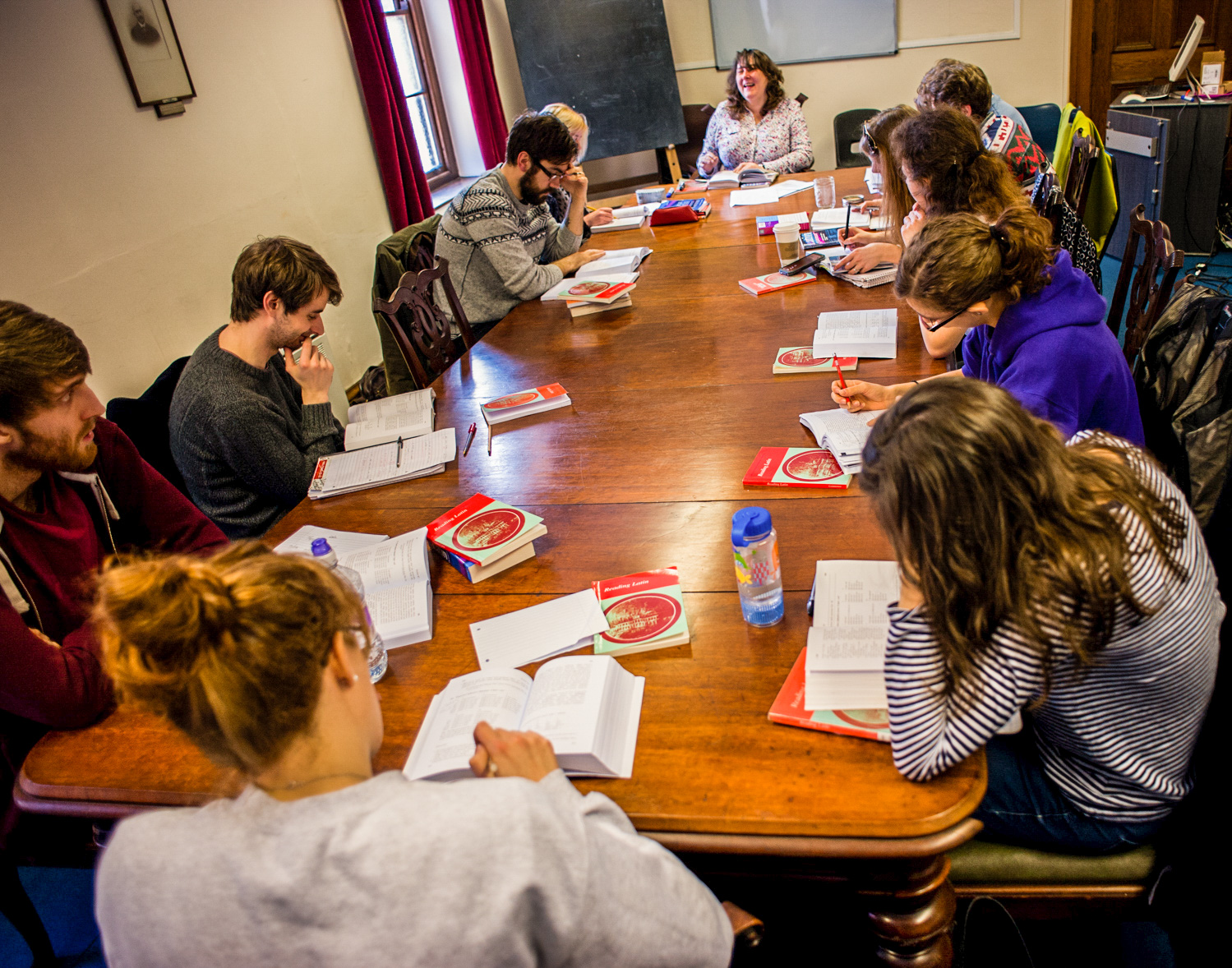 Classics and Ancient History students reading round a seminar table.