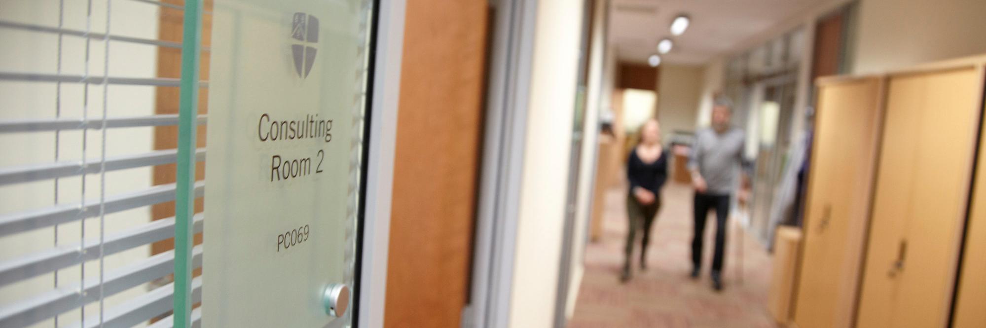 Two people walking towards the Disability services