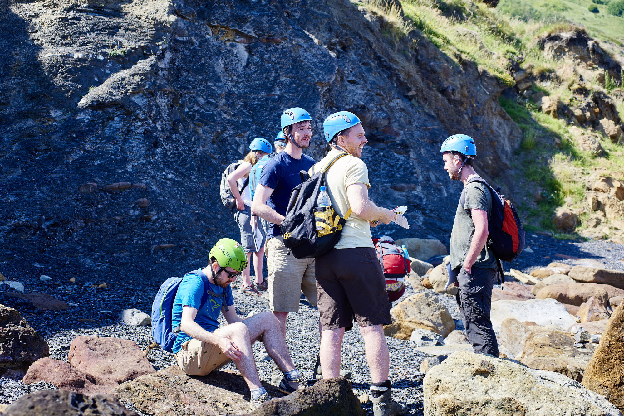 Group of people with hard helmets talking