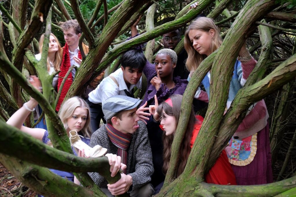 Durham theatre students posed in tree branches