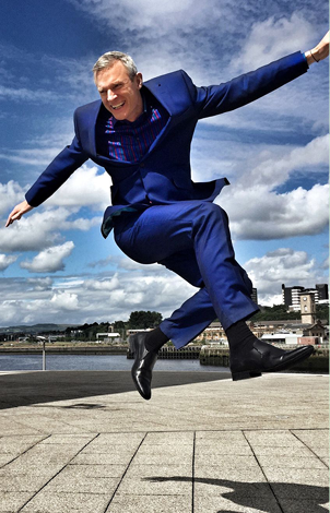Photograph of a happy man leaping into the air