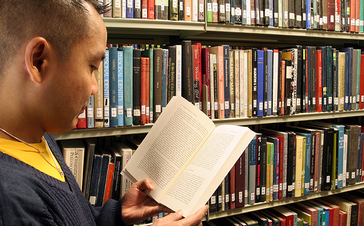 A research student Reading a book in Bill Bryson Library
