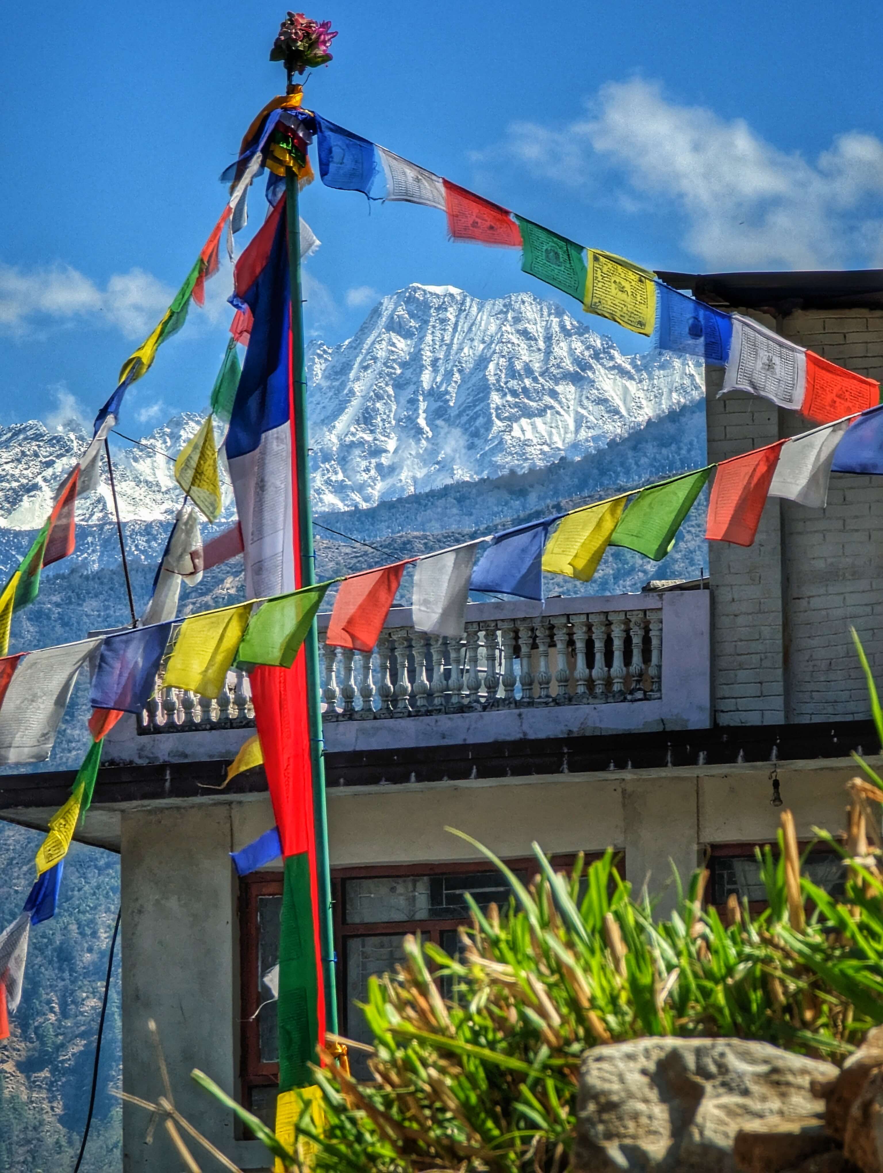 Prayer flags with a mountain behind them