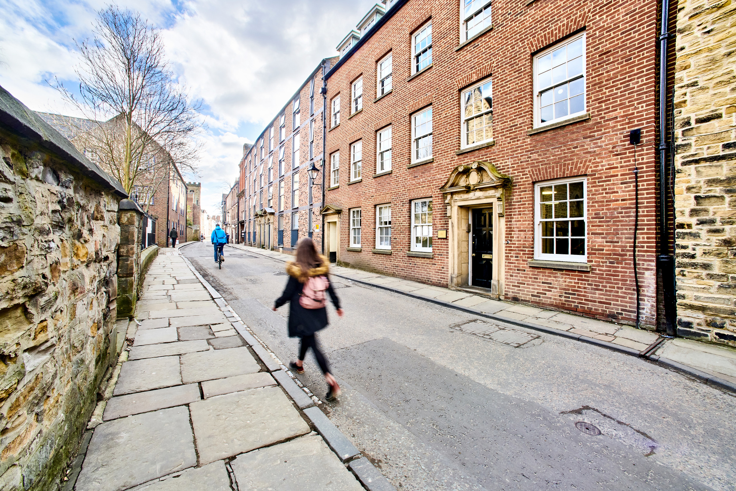 Student walking outside the Department of History