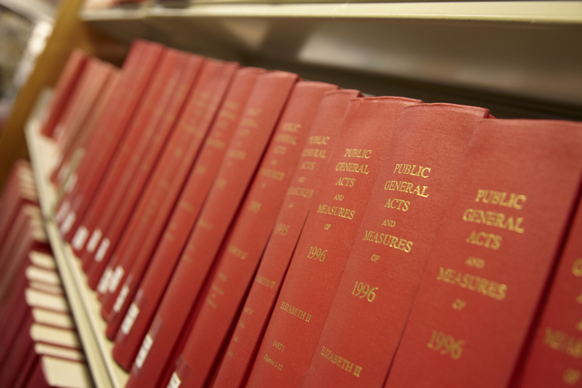 Close-up of red law books on shelf