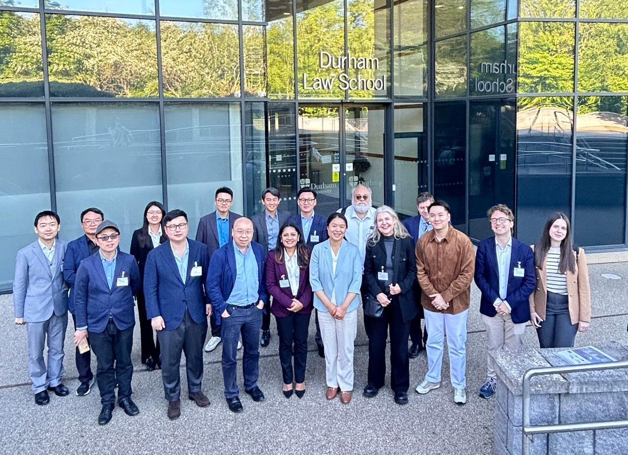 a cropped version of conference attendees outside the Law School