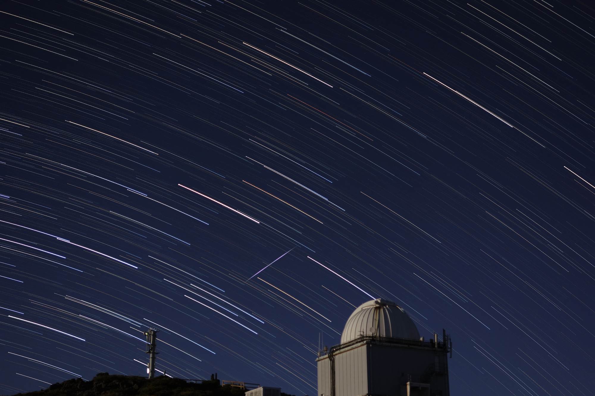 Star trail with satellite over telescope