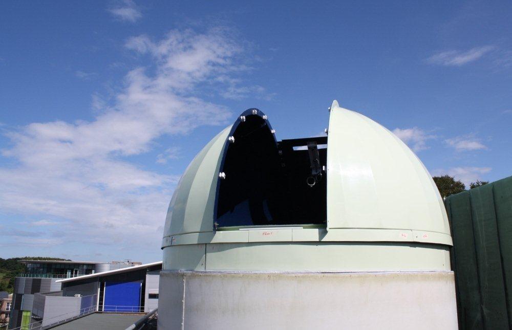 Open telescope dome with view of Calman Learning Centre and Science site