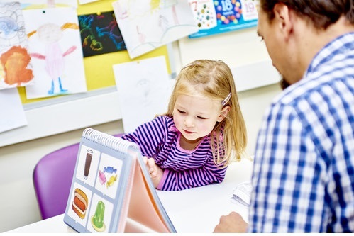 A child with researcher, taking part in a memory based experiment