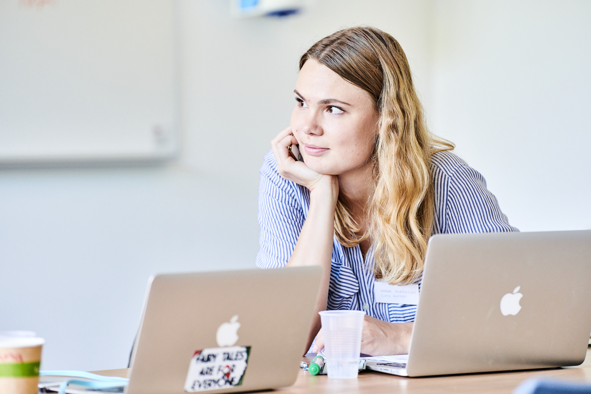 A student sat at a laptop and listening